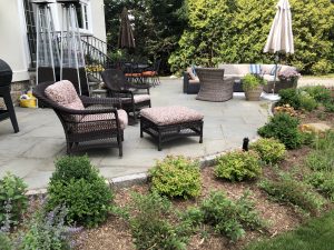This Rochelle backyard's patio is now bordered by flowering shrubs and perennials