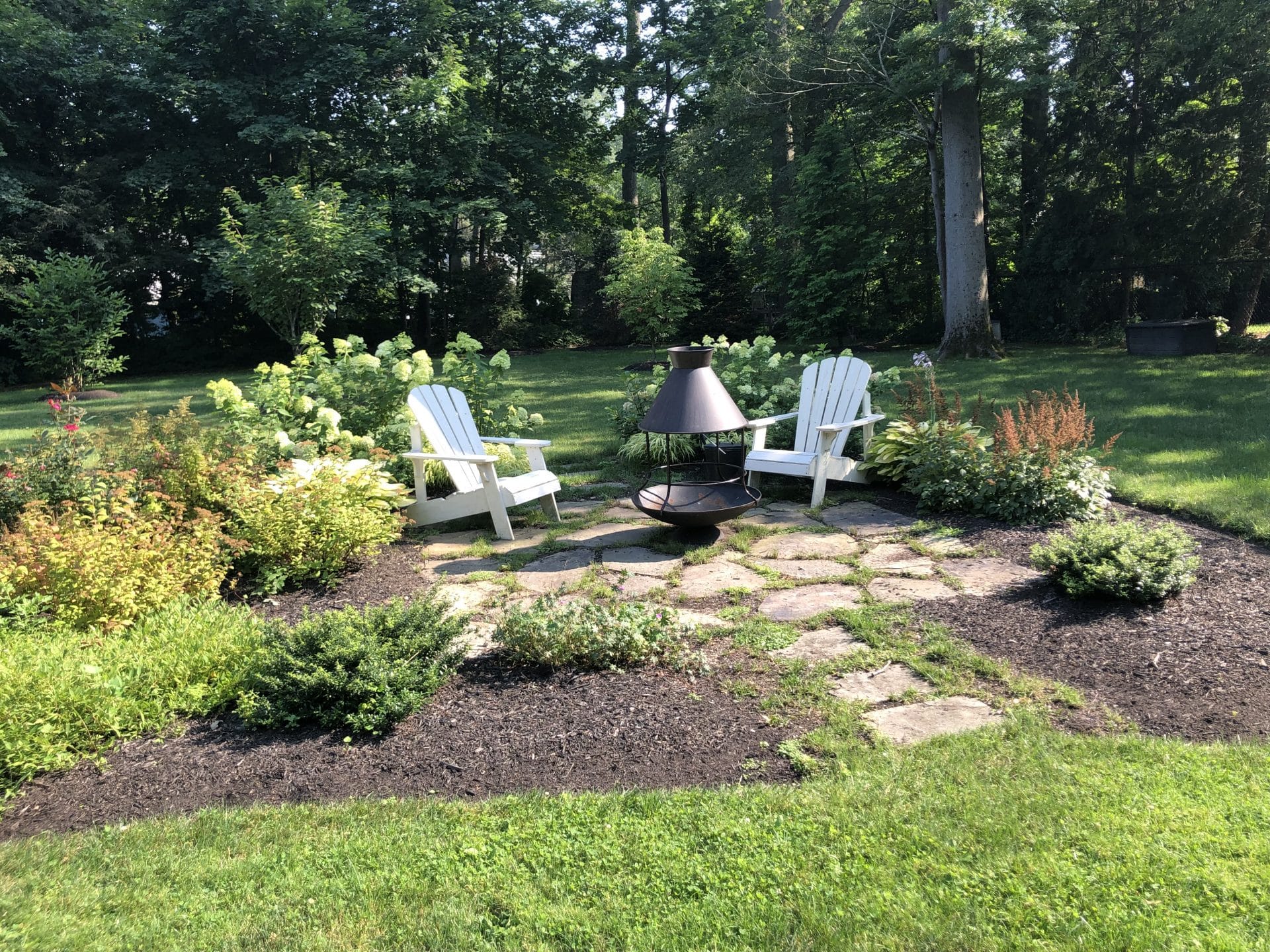 This Scarsdale natural stone patio has been situated as a floating island of plantings where one can relax and enjoy their surroundings